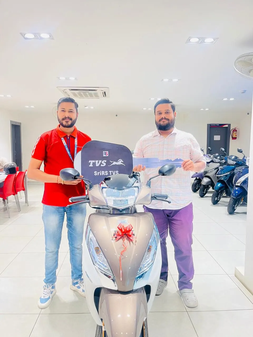 Customer receiving keys to their TVS Jupiter