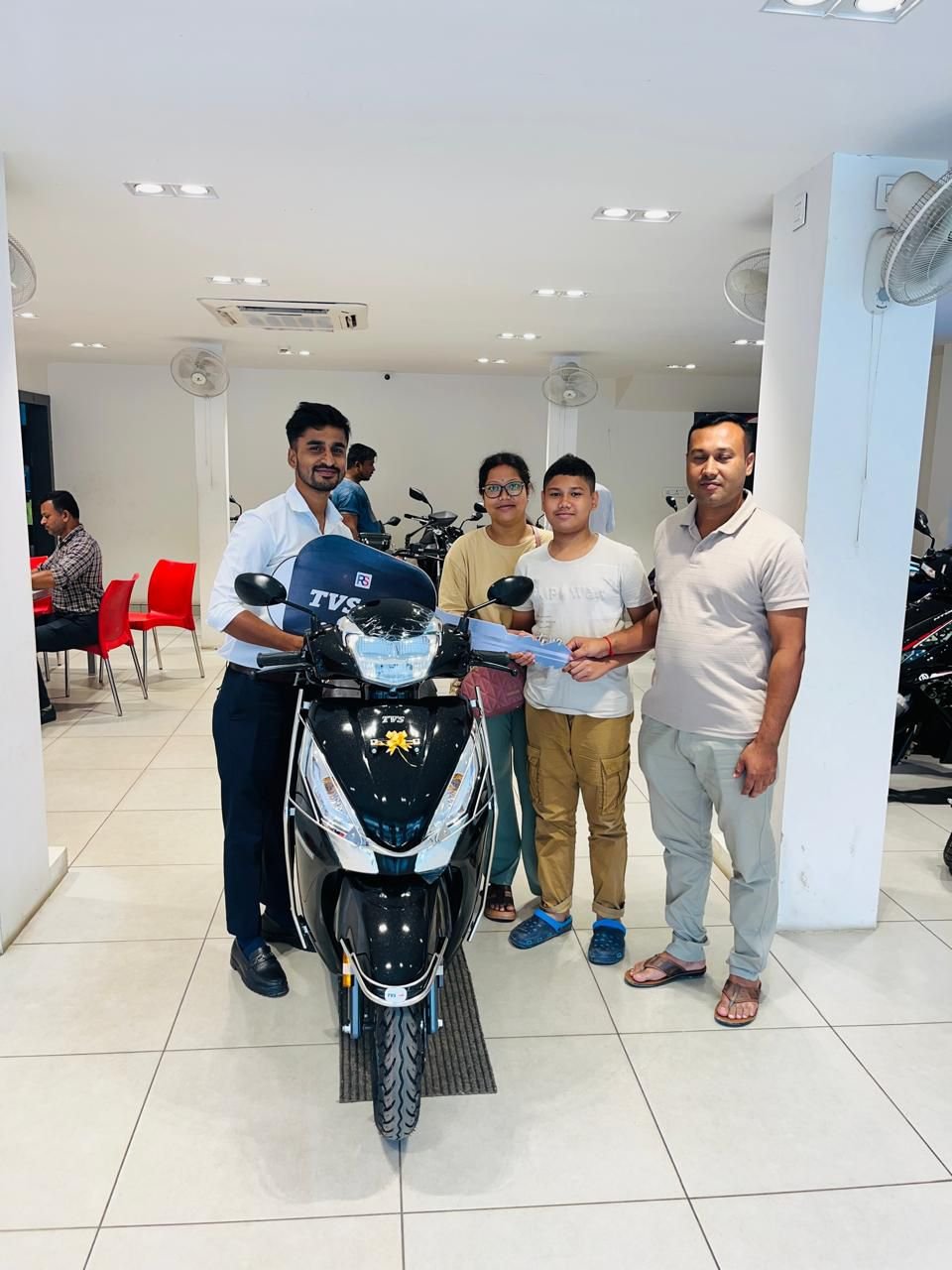 A family with their new TVS Jupiter